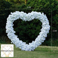 White heart-shaped wedding party background floral arch decoration