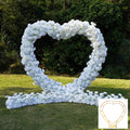 White heart-shaped wedding party background floral arch decoration